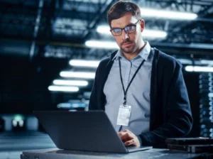 Man working on a laptop in office setup